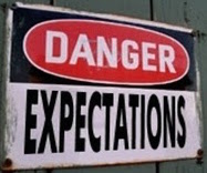 Signboard with text - Danger! Expectations